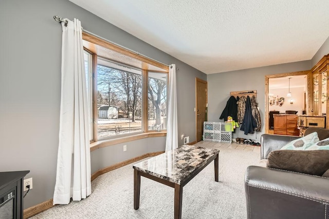 carpeted living room featuring a textured ceiling