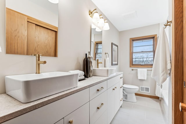 bathroom featuring tile patterned flooring, vanity, and toilet