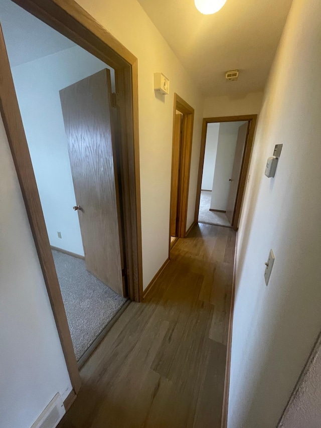 corridor with wood-type flooring