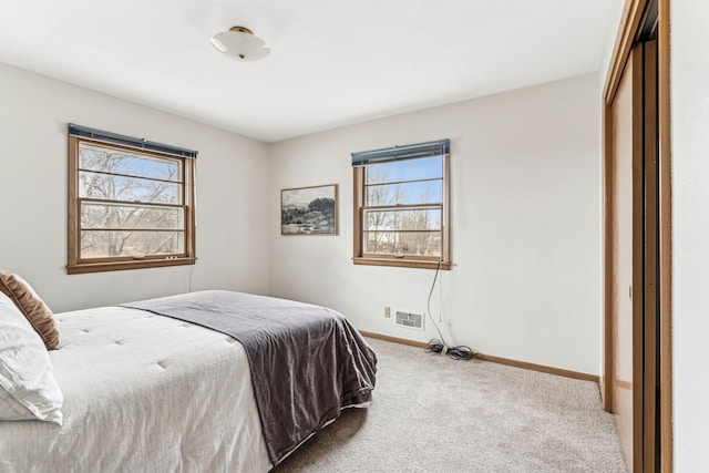 carpeted bedroom with a closet