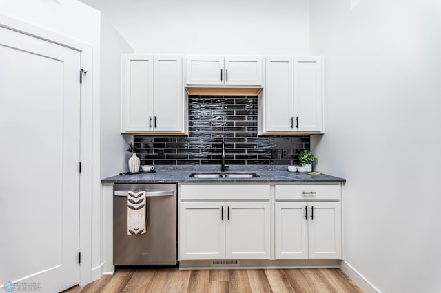 kitchen with dishwasher, white cabinets, light hardwood / wood-style floors, and sink