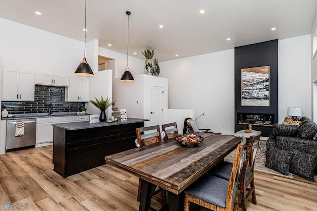 dining room featuring light wood-type flooring and sink