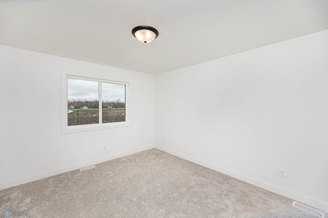 spare room with light colored carpet