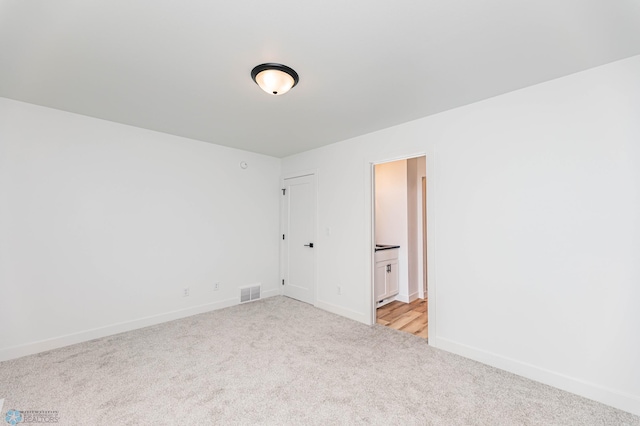 unfurnished room with light colored carpet