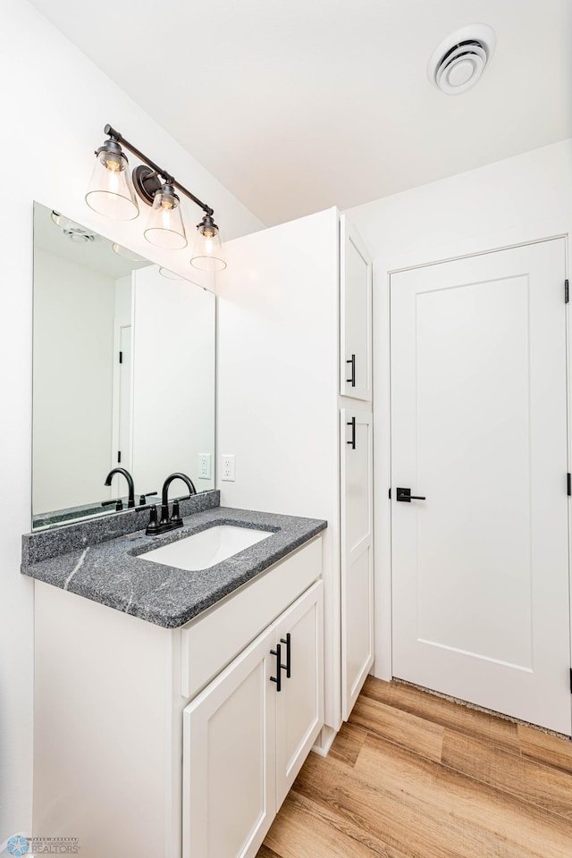 bathroom featuring vanity and wood-type flooring