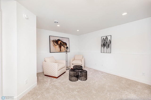 living area featuring light colored carpet