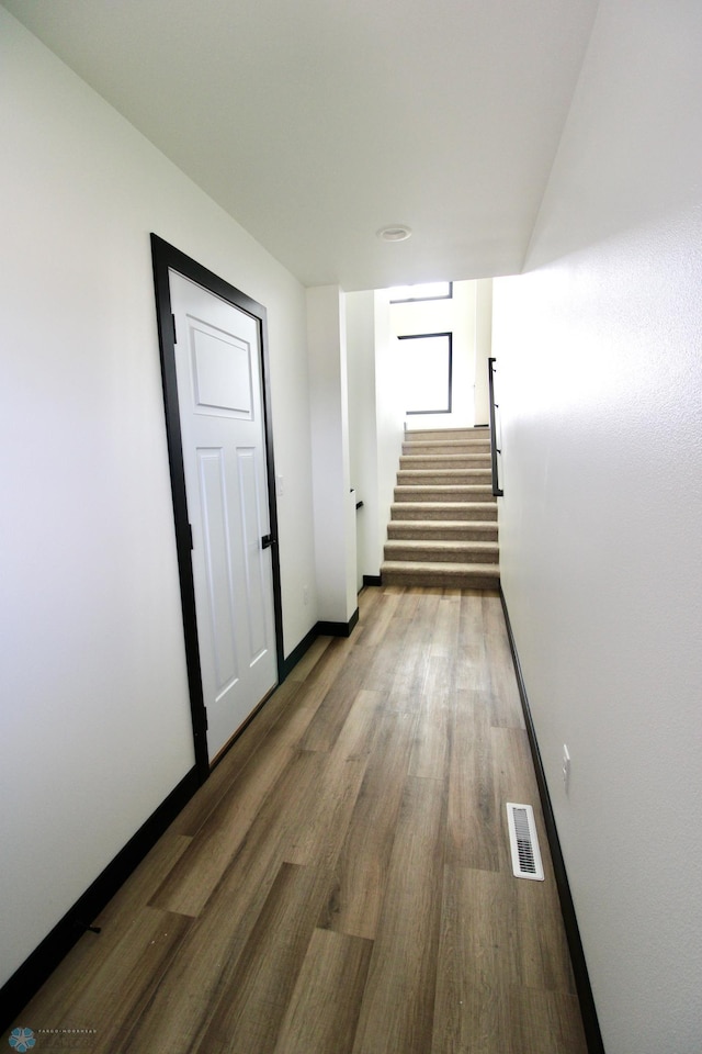 6721 67th Ave S, Horace, ND 58047 - corridor featuring stairway, wood finished floors, and baseboards