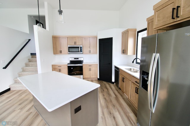 6721 67th Ave S, Horace, ND 58047 - kitchen featuring stainless steel appliances, a sink, light wood-style floors, light countertops, and a high ceiling