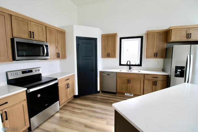 6721 67th Ave S, Horace, ND 58047 - kitchen with stainless steel appliances, a sink, light countertops, and light wood finished floors