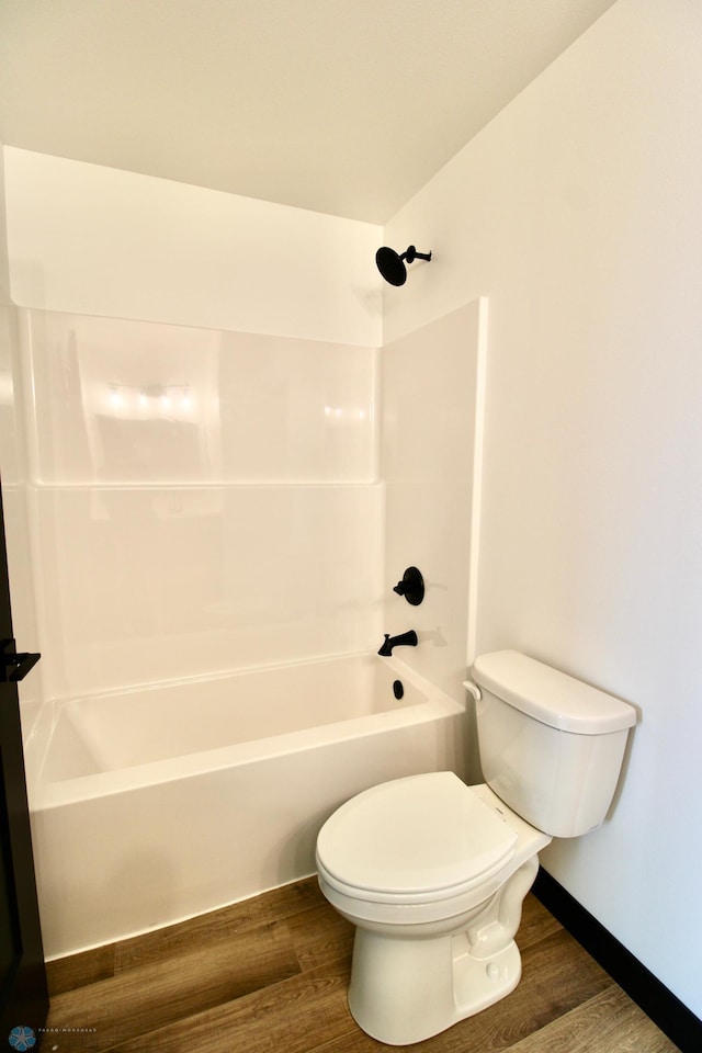 6721 67th Ave S, Horace, ND 58047 - bathroom featuring toilet, wood finished floors, tub / shower combination, and baseboards