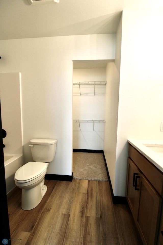 6721 67th Ave S, Horace, ND 58047 - full bath with wood finished floors, vanity, toilet, baseboards, and  shower combination