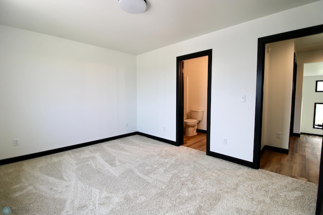 6721 67th Ave S, Horace, ND 58047 - unfurnished bedroom with carpet floors, baseboards, and ensuite bath