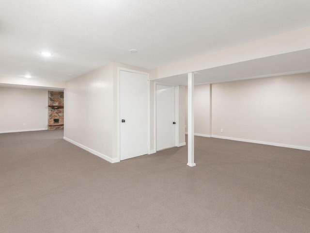 basement featuring dark carpet