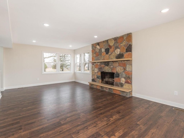 unfurnished living room with a fireplace and dark hardwood / wood-style flooring