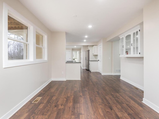 unfurnished living room featuring dark wood-type flooring