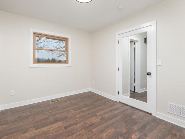 empty room featuring dark wood-type flooring