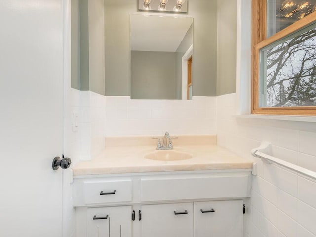 bathroom with vanity and tile walls