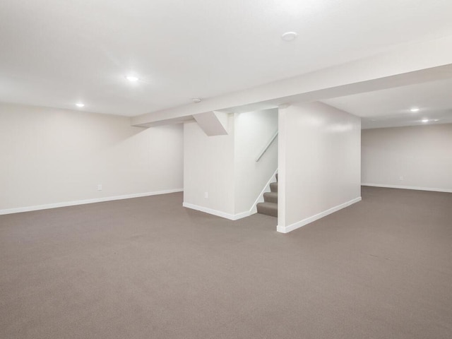 basement featuring dark colored carpet