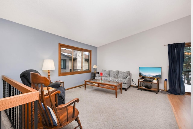 living room with hardwood / wood-style floors and vaulted ceiling