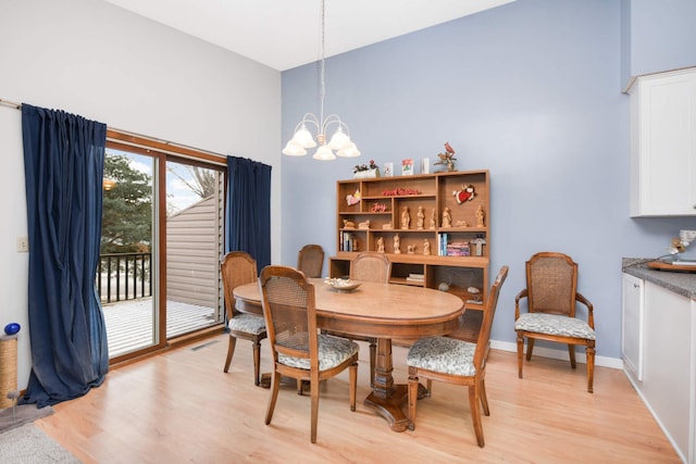 dining room with an inviting chandelier and light wood-type flooring