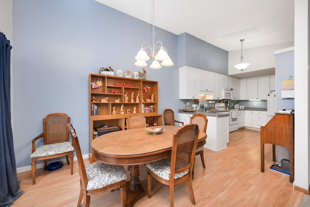 dining room with a chandelier and light wood-type flooring