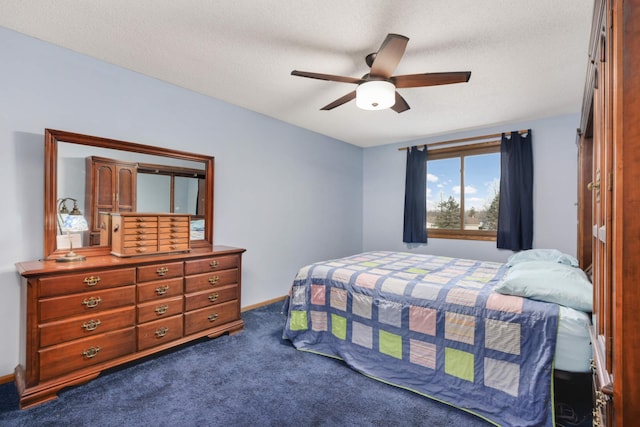 carpeted bedroom featuring ceiling fan and a textured ceiling