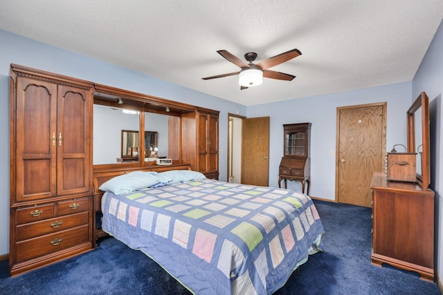 carpeted bedroom featuring ceiling fan and a textured ceiling