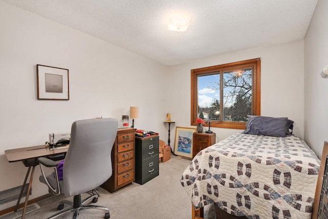 bedroom with light colored carpet and a textured ceiling