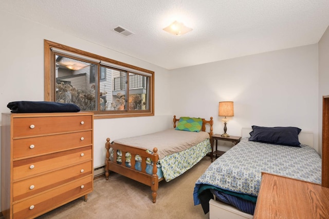 carpeted bedroom featuring a textured ceiling and a baseboard radiator