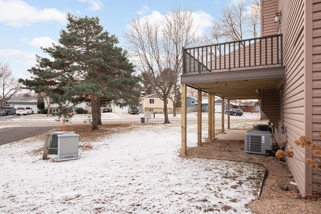 snowy yard with central air condition unit