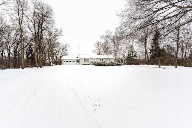 yard layered in snow with a garage