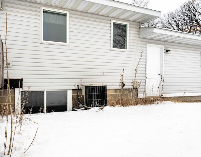 view of snow covered exterior with central air condition unit