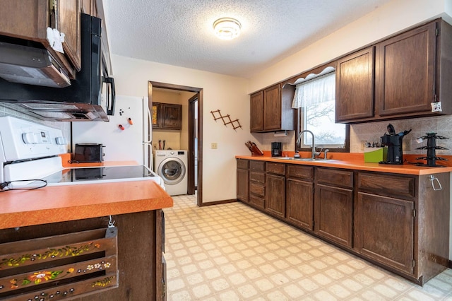 kitchen featuring washer / dryer, dark brown cabinetry, and sink