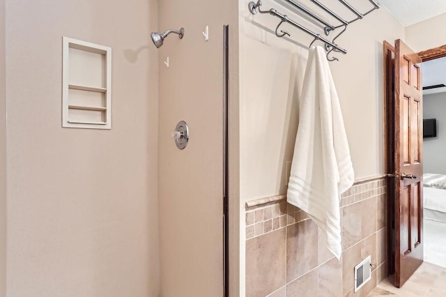 bathroom with tile walls and walk in shower