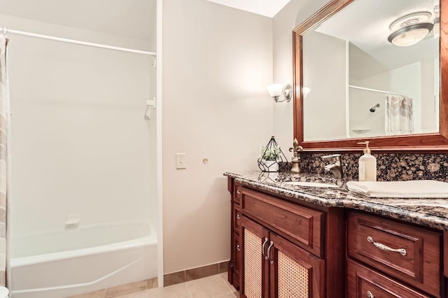 bathroom featuring tile patterned flooring, vanity, decorative backsplash, and shower / bath combo