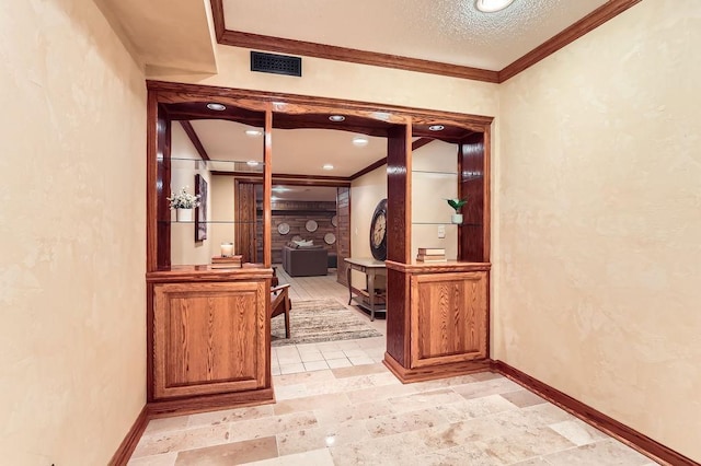 hallway with crown molding and a textured ceiling