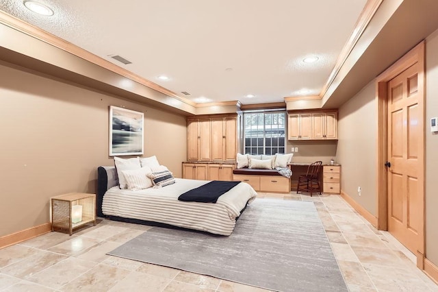 bedroom with crown molding and built in desk