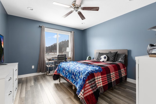 bedroom with dark hardwood / wood-style flooring and ceiling fan