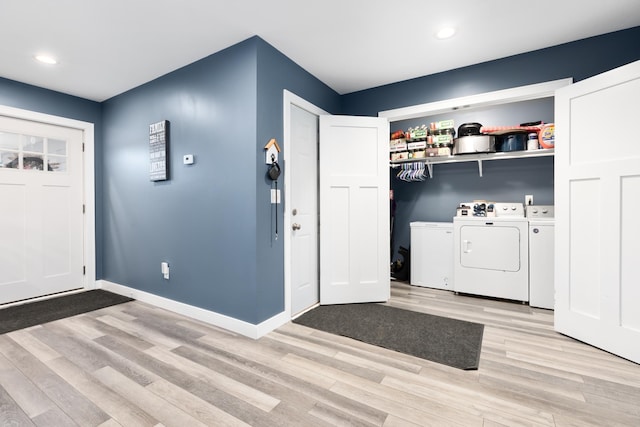 washroom featuring light wood-type flooring and washer and clothes dryer