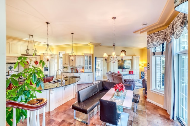 dining room featuring sink and ornamental molding