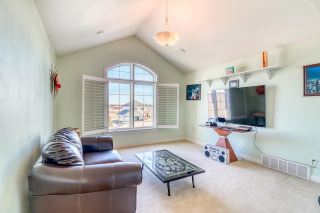 carpeted living room featuring lofted ceiling and a healthy amount of sunlight