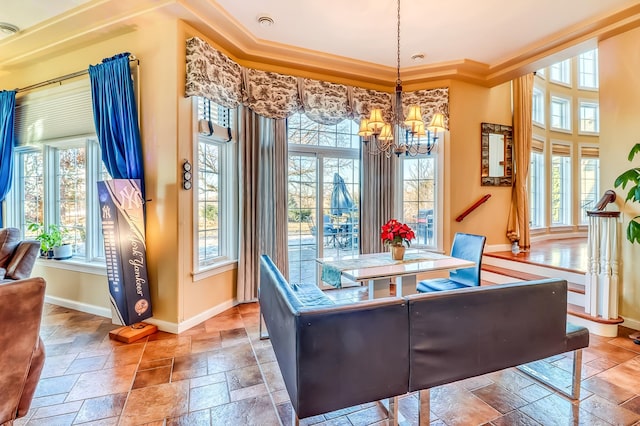 dining space with crown molding and an inviting chandelier