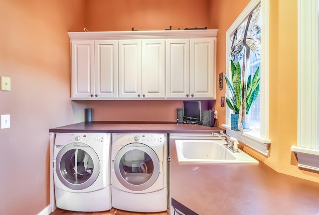 washroom featuring cabinets, washer and dryer, and sink