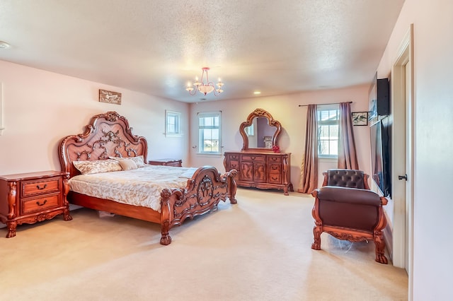 carpeted bedroom with a textured ceiling and a chandelier