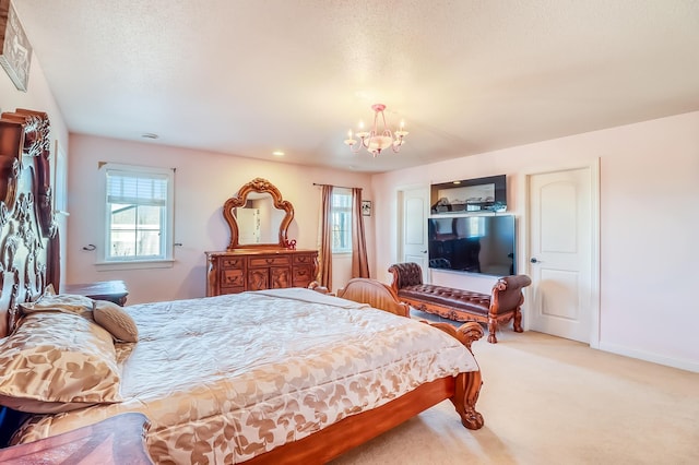 bedroom with light colored carpet, a textured ceiling, and a chandelier