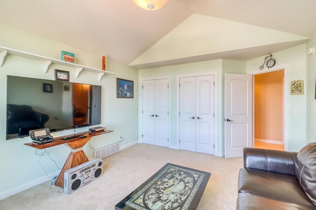 office space featuring light carpet and vaulted ceiling