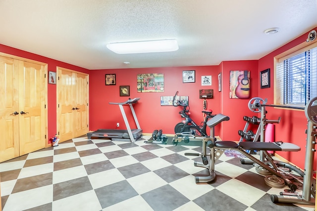 exercise room with a textured ceiling