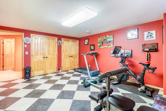 workout area featuring a textured ceiling