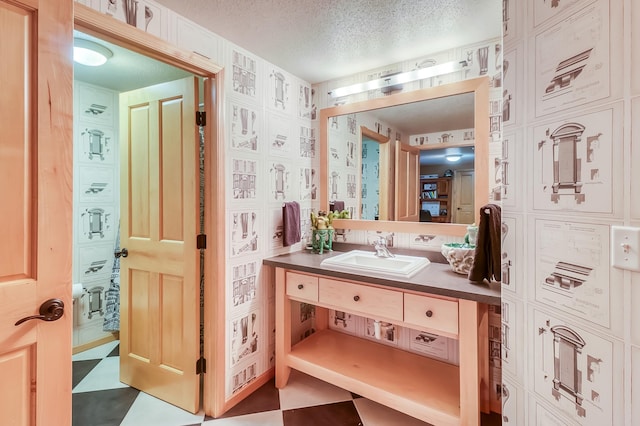 bathroom with a textured ceiling and vanity