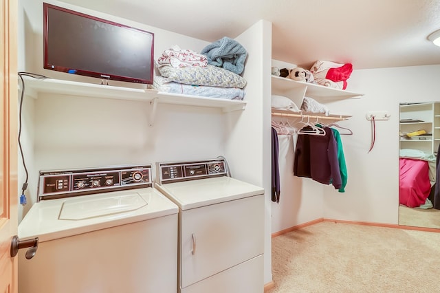 laundry area with washer and dryer and light carpet